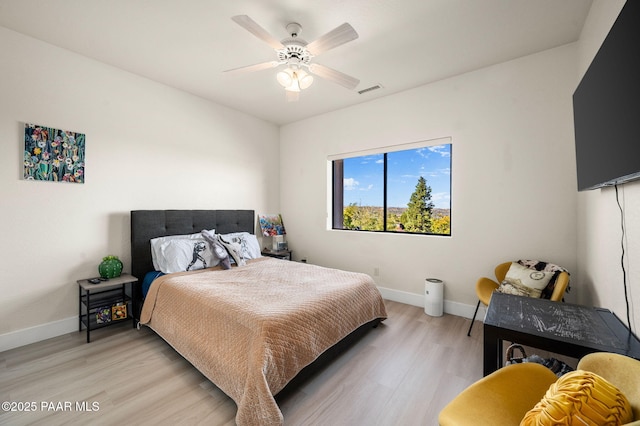 bedroom featuring light hardwood / wood-style floors and ceiling fan