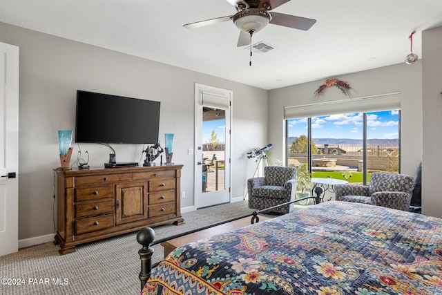 bedroom with access to outside, ceiling fan, and light colored carpet