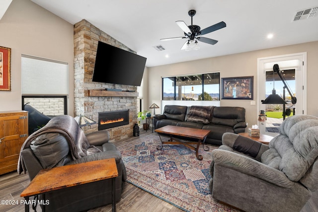 living room with a fireplace, hardwood / wood-style flooring, and a wealth of natural light