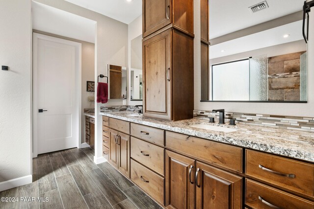 bathroom featuring decorative backsplash, vanity, and hardwood / wood-style flooring