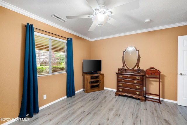 bedroom with ornamental molding, wood finished floors, baseboards, and a ceiling fan