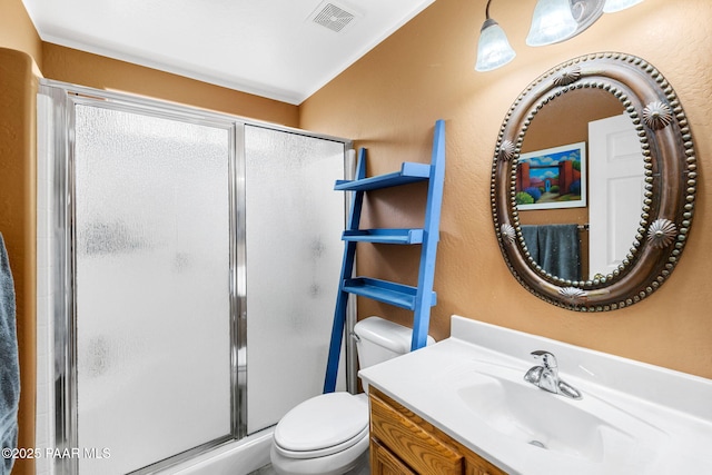 full bath featuring a shower stall, toilet, vanity, and a textured wall