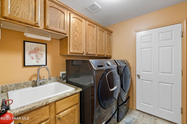 7785 E Bramble Berry Ln, Prescott Valley, AZ 86315 - laundry area with cabinet space and washer and clothes dryer