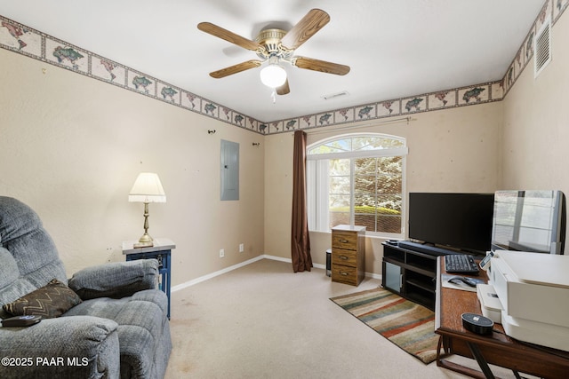 office area with carpet, baseboards, ceiling fan, and electric panel