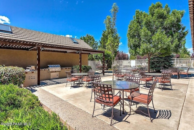 7785 E Bramble Berry Ln, Prescott Valley, AZ 86315 - view of patio / terrace with fence, an outdoor kitchen, and area for grilling