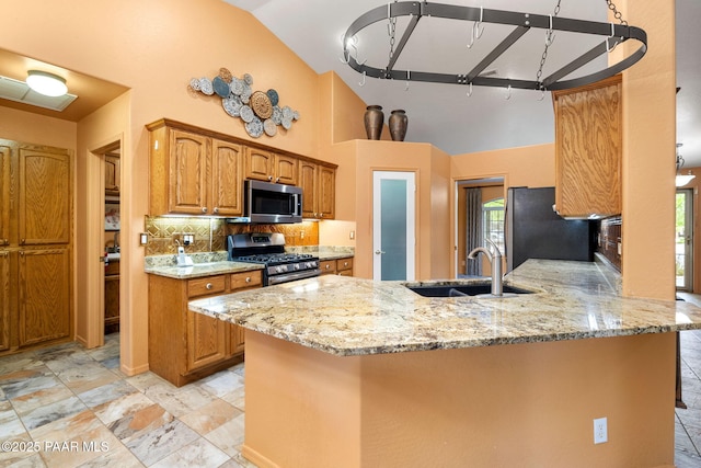 7785 E Bramble Berry Ln, Prescott Valley, AZ 86315 - kitchen with stainless steel appliances, a sink, light stone counters, tasteful backsplash, and high vaulted ceiling