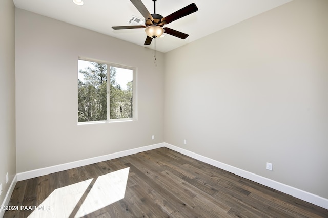 unfurnished room featuring ceiling fan, baseboards, dark wood-style floors, and visible vents