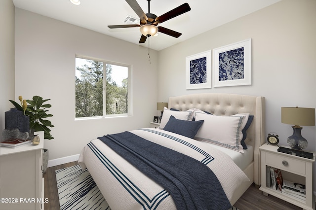 bedroom featuring baseboards, visible vents, a ceiling fan, and dark wood-style floors