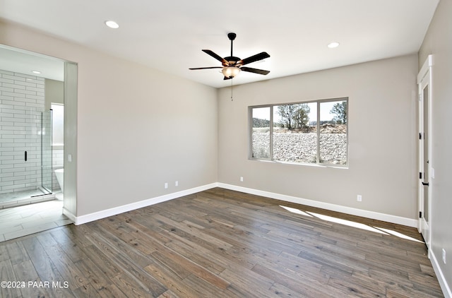 spare room featuring wood-type flooring, baseboards, ceiling fan, and recessed lighting