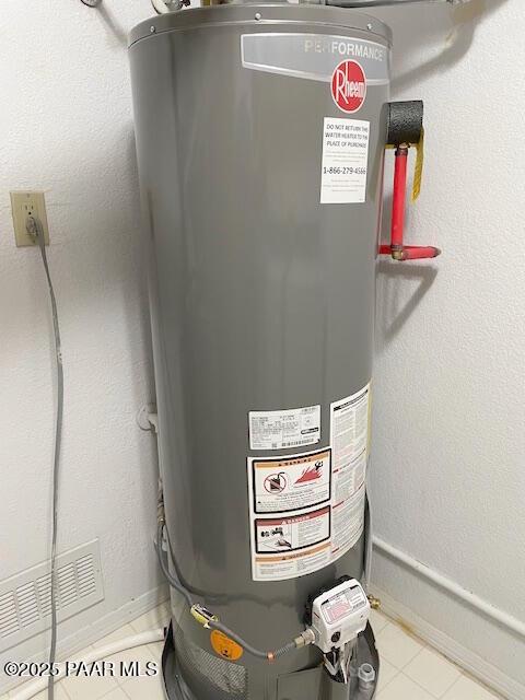 utility room featuring gas water heater