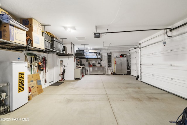 garage with a garage door opener and refrigerator