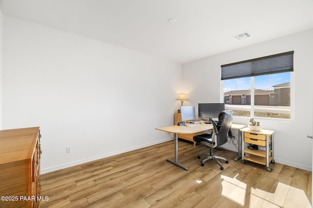 home office featuring baseboards, visible vents, and wood finished floors