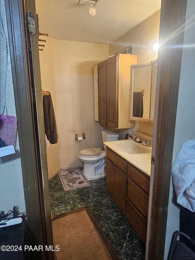 bathroom featuring vanity and toilet