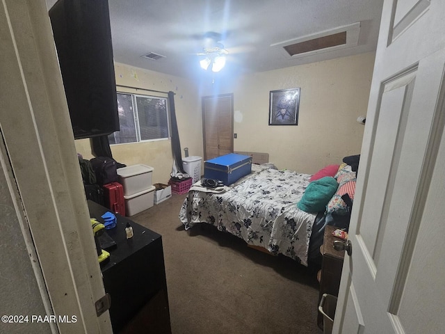 bedroom with ceiling fan and dark colored carpet