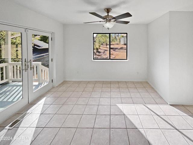 spare room with ceiling fan, french doors, and light tile patterned floors