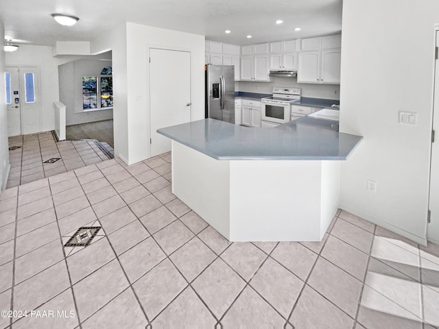 kitchen with white cabinetry, stainless steel fridge, white electric range oven, light tile patterned flooring, and kitchen peninsula