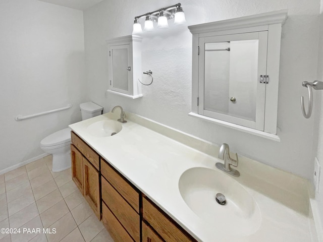 bathroom with tile patterned floors, vanity, and toilet