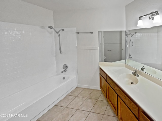 full bathroom featuring vanity, tile patterned flooring, tiled shower / bath, and toilet