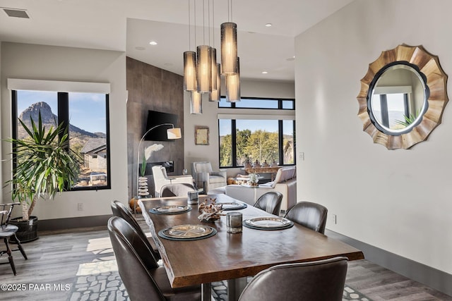 dining space featuring light wood-type flooring and a chandelier