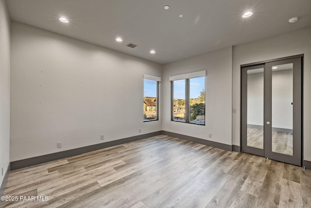 empty room with light hardwood / wood-style flooring