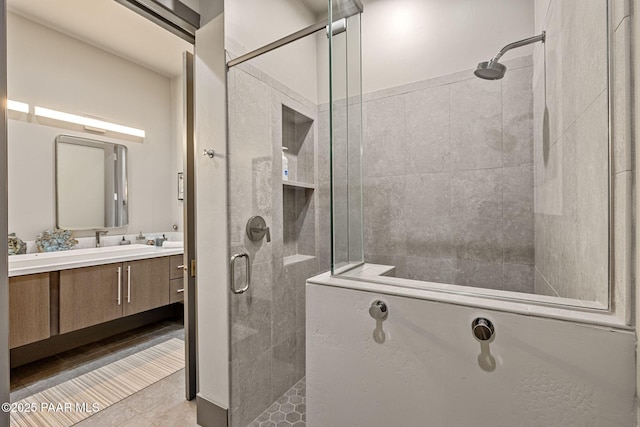 bathroom with tile patterned flooring, vanity, and an enclosed shower