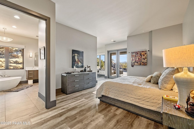 bedroom with access to exterior, french doors, and light wood-type flooring