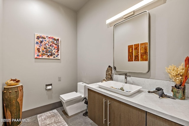 bathroom with tile patterned flooring, vanity, and toilet