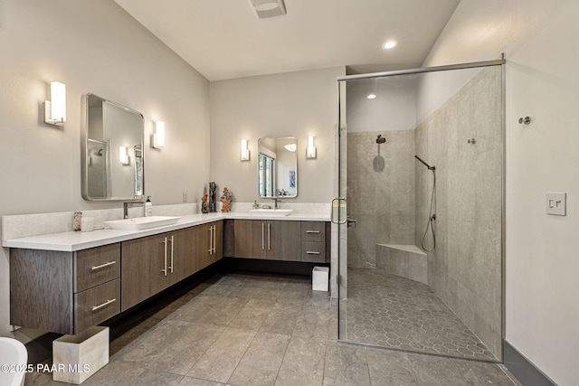 bathroom with vanity and a shower with shower door