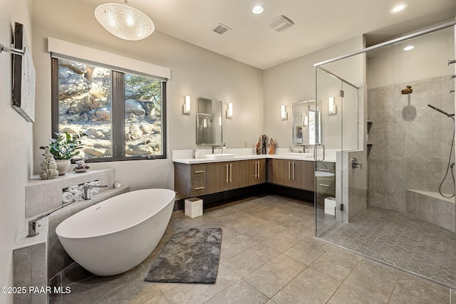 bathroom featuring shower with separate bathtub and vanity