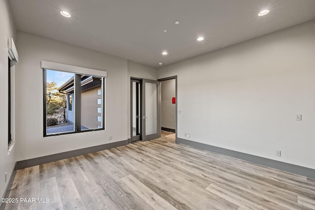 empty room with light hardwood / wood-style floors