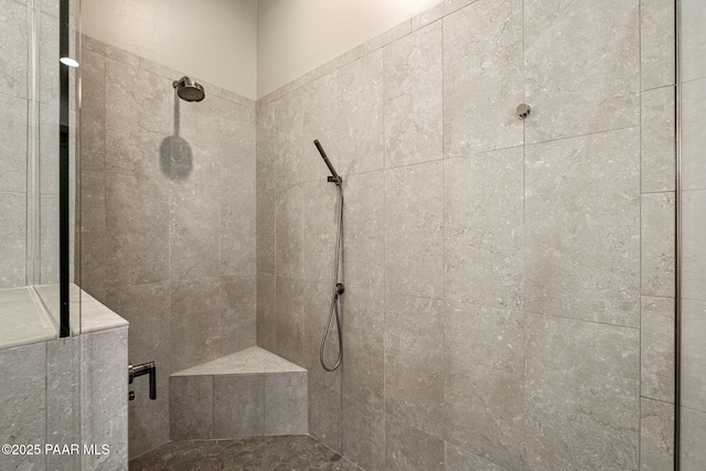 bathroom with a tile shower