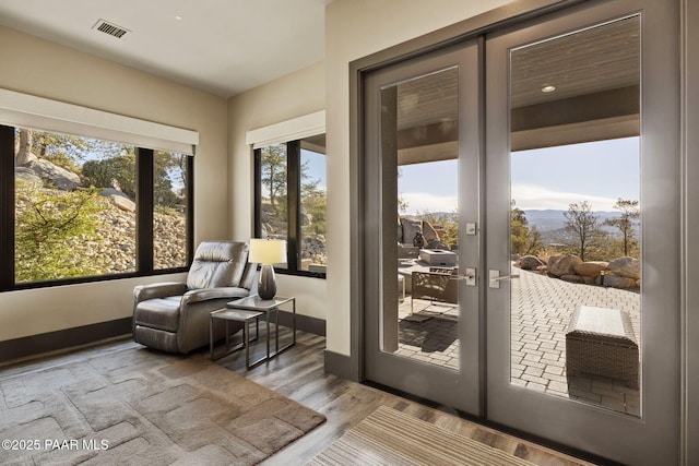 doorway with french doors and hardwood / wood-style floors