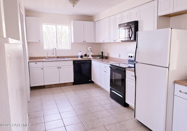 kitchen with light tile patterned floors, light countertops, white cabinets, a sink, and black appliances