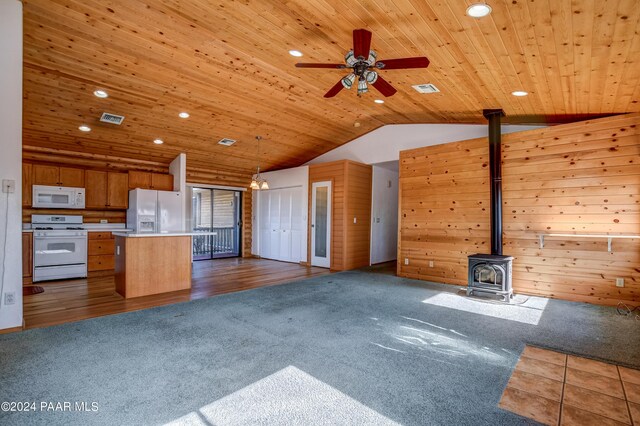 2570 S Colina Ln, Dewey-Humboldt, AZ 86329 - unfurnished living room featuring a wood stove, wood ceiling, dark colored carpet, lofted ceiling, and recessed lighting