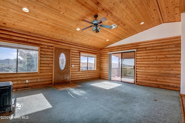 2570 S Colina Ln, Dewey-Humboldt, AZ 86329 - unfurnished living room with wooden ceiling, a wood stove, plenty of natural light, vaulted ceiling, and ceiling fan