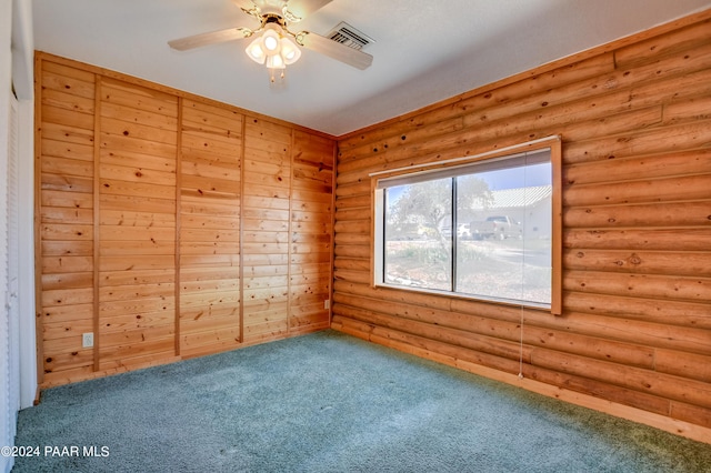 2570 S Colina Ln, Dewey-Humboldt, AZ 86329 - empty room with log walls, carpet flooring, and a ceiling fan