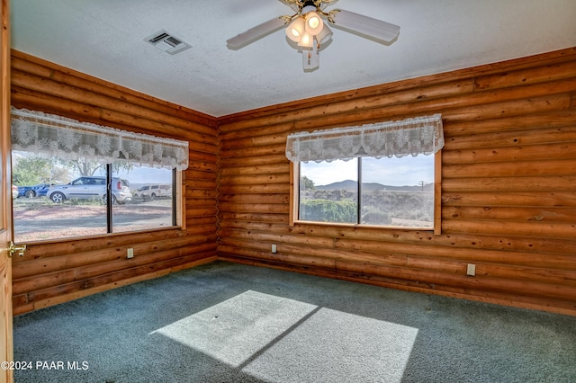 2570 S Colina Ln, Dewey-Humboldt, AZ 86329 - carpeted spare room featuring healthy amount of natural light, ceiling fan, and rustic walls
