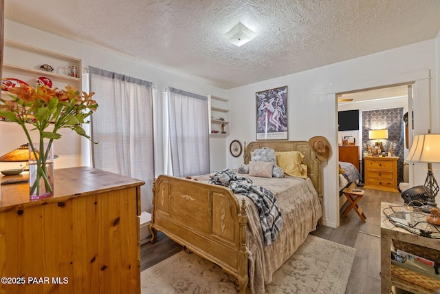 bedroom featuring light wood-type flooring and a textured ceiling