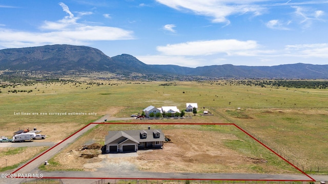 birds eye view of property with a mountain view and a rural view
