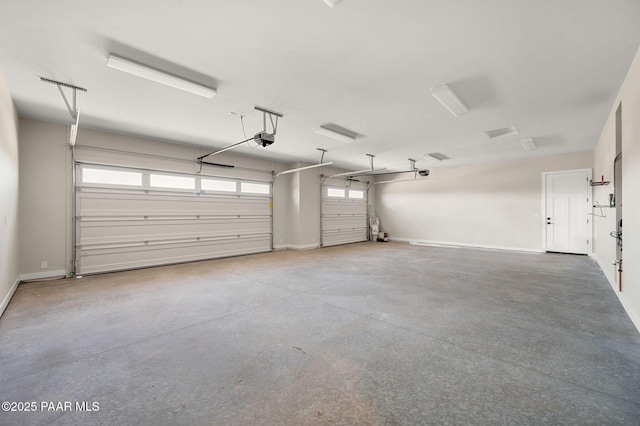 garage with a garage door opener and baseboards