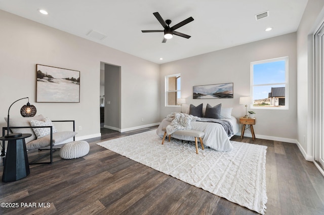 bedroom featuring dark wood finished floors, multiple windows, and visible vents