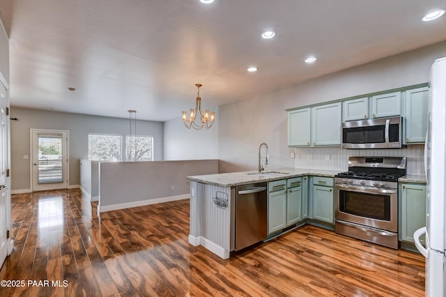 1017 N Fairway Dr, Dewey-Humboldt, AZ 86327 - kitchen featuring appliances with stainless steel finishes, a sink, a peninsula, backsplash, and a chandelier