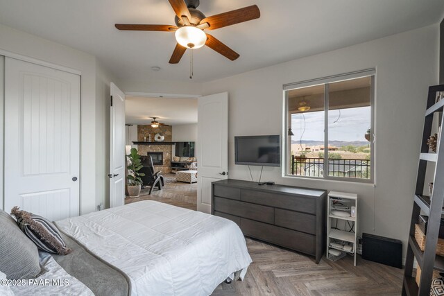 10550 E Cumberland Ct, Dewey-Humboldt, AZ 86327 - bedroom featuring a closet, ceiling fan, and a fireplace