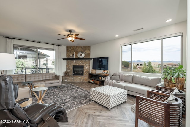 10550 E Cumberland Ct, Dewey-Humboldt, AZ 86327 - living area with a ceiling fan, visible vents, a stone fireplace, and recessed lighting