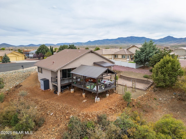 10550 E Cumberland Ct, Dewey-Humboldt, AZ 86327 - back of house with fence, stucco siding, a deck with mountain view, and a tile roof