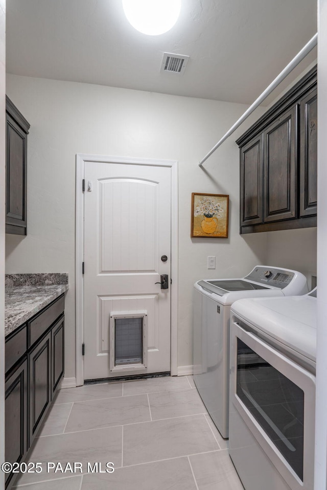 10550 E Cumberland Ct, Dewey-Humboldt, AZ 86327 - laundry room featuring visible vents, cabinet space, baseboards, and washing machine and clothes dryer
