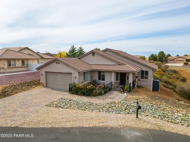 10550 E Cumberland Ct, Dewey-Humboldt, AZ 86327 - ranch-style home featuring fence, an attached garage, a tile roof, stucco siding, and decorative driveway