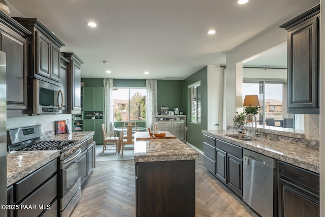 10550 E Cumberland Ct, Dewey-Humboldt, AZ 86327 - kitchen with dark brown cabinets, appliances with stainless steel finishes, a sink, recessed lighting, and a kitchen island