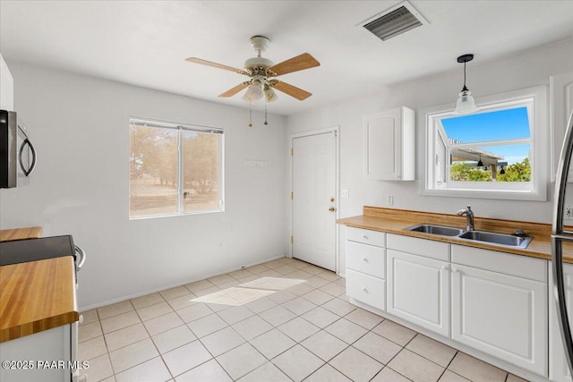 20249 E Prickly Pear Dr, Mayer, AZ 86333 - kitchen with stainless steel microwave, a ceiling fan, butcher block counters, and plenty of natural light
