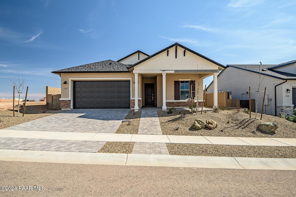 view of front of house featuring a garage and covered porch